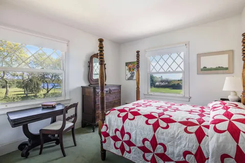 a bedroom with two beds and a window