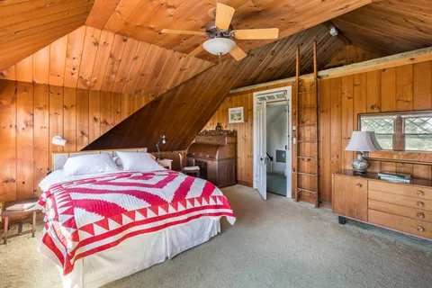 a bedroom with a bed and window