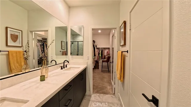 a bathroom with a double vanity sink a mirror and a shower