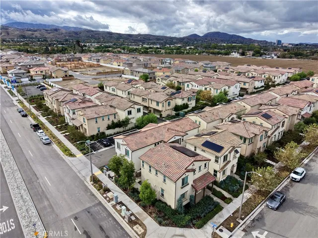 an aerial view of residential houses with yard