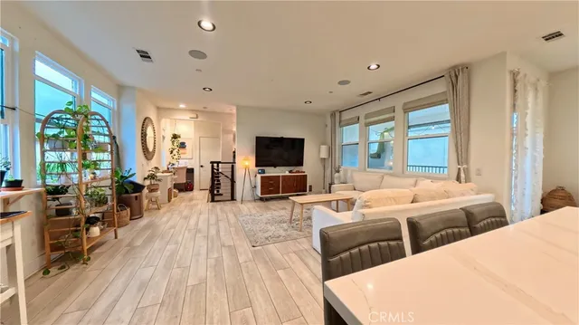 a large bedroom with three beds and a large window