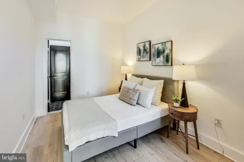 a bedroom with a bed and a night stand