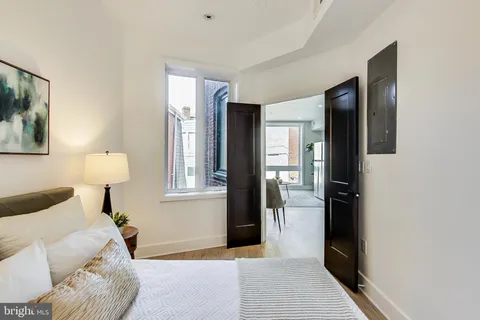 a living room with furniture and a lamp