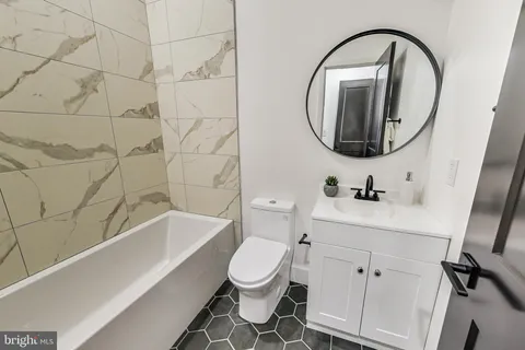 a bathroom with a sink a toilet and a mirror