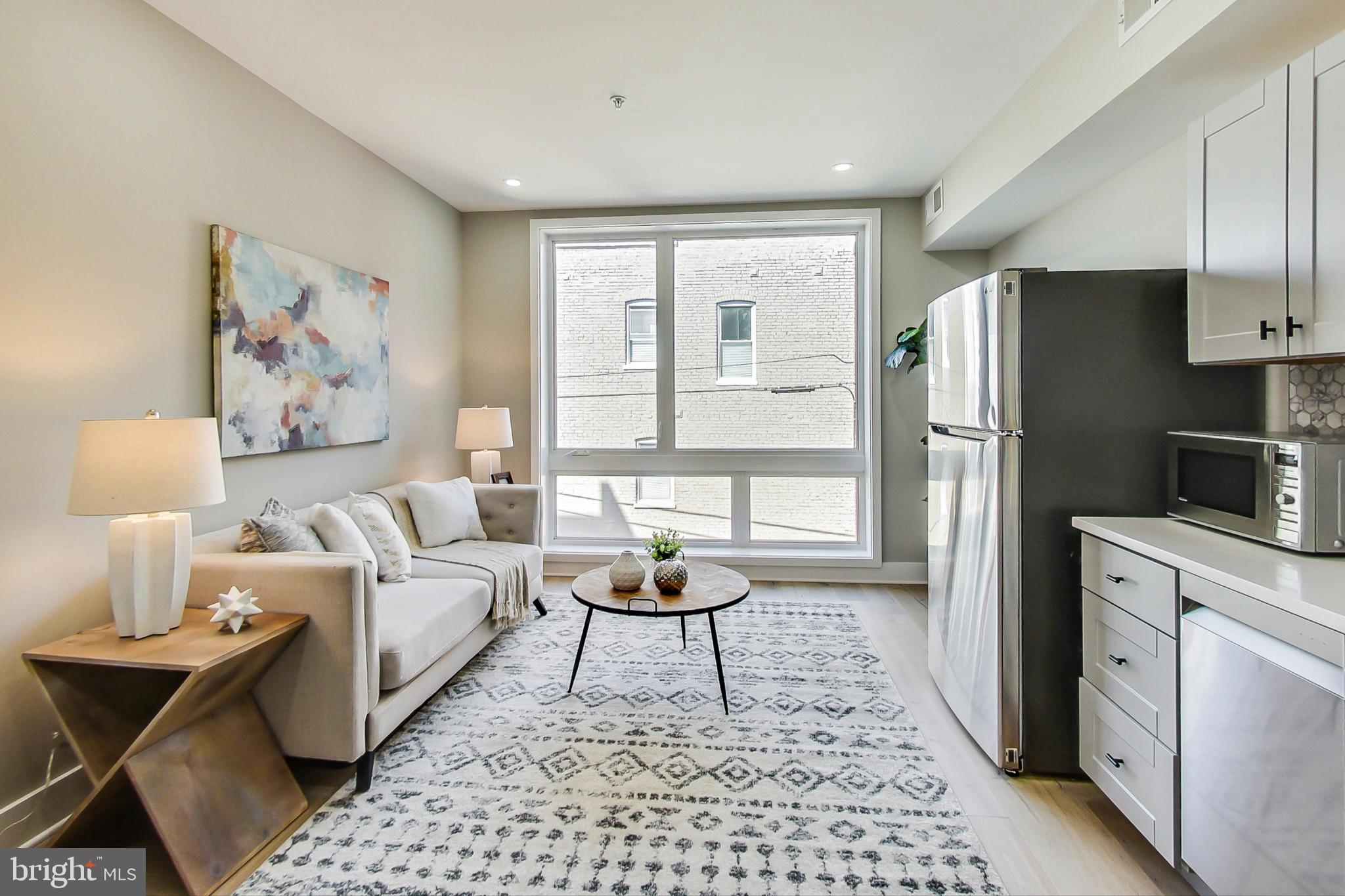 207 Florida Avenue Northwest, Unit 2 Washington, DC 20001 - Photo 2 of 18 a living room with furniture and a window