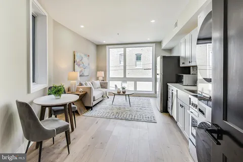 a living room with fireplace furniture and a flat screen tv
