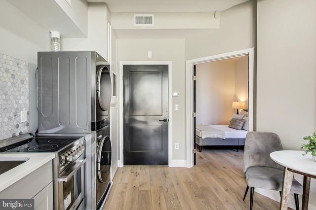a kitchen with a refrigerator and furniture