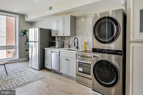 a kitchen with a washer and dryer