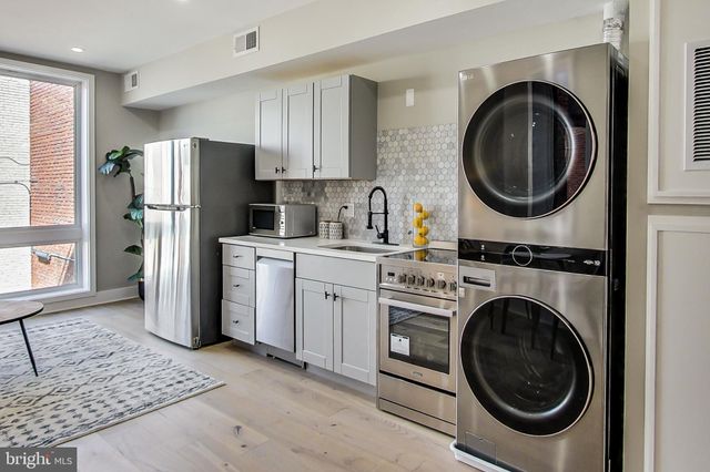 a kitchen with a washer and dryer