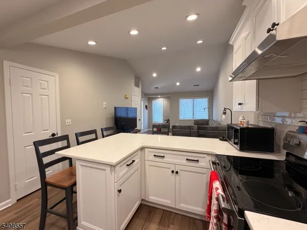 a kitchen with a sink appliances and cabinets