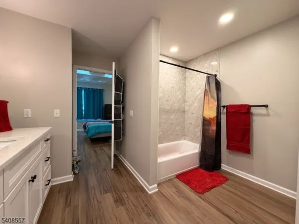 a bathroom with a shower and a sink