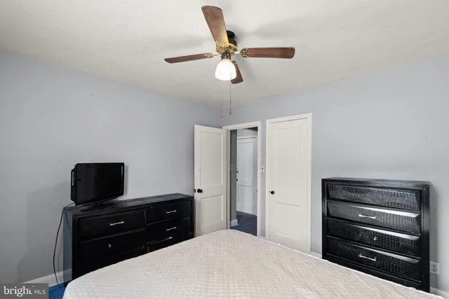 a bedroom with a bed and a television