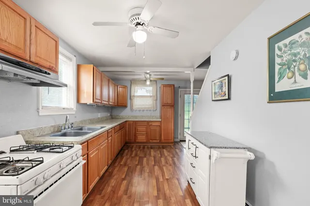 a kitchen with a stove a sink and a refrigerator
