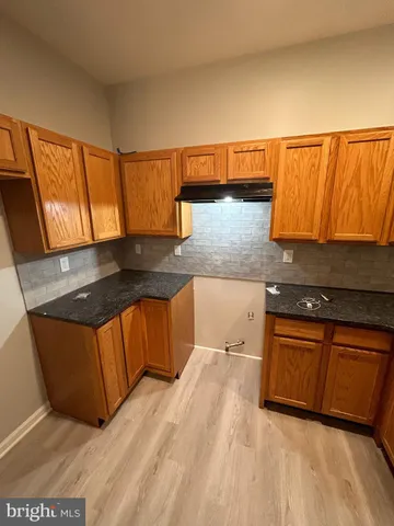 a kitchen with stainless steel appliances granite countertop a sink a stove and a microwave