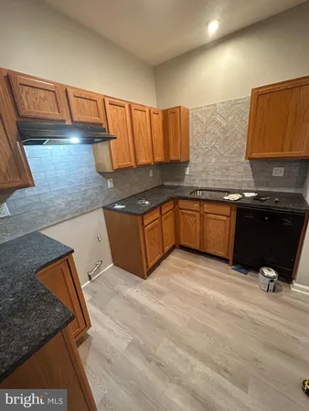 a kitchen with stainless steel appliances granite countertop a sink and a granite counter tops
