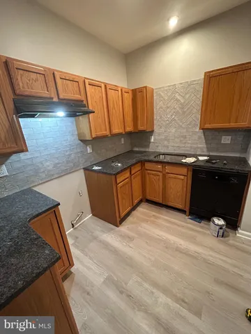 a kitchen with stainless steel appliances granite countertop a sink and a granite counter tops