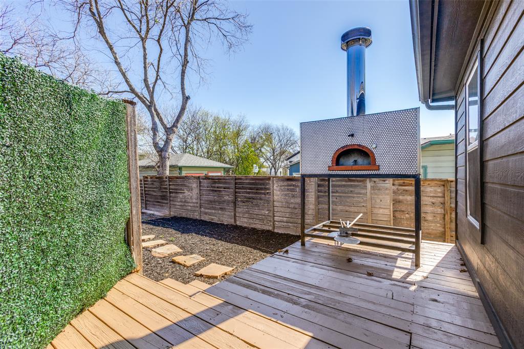 2012 Payne Avenue, Unit A Austin, TX 78757 - Photo 26 of 33 Outdoor deck with a built-in pizza oven, featuring a tiled facade and integrated chimney