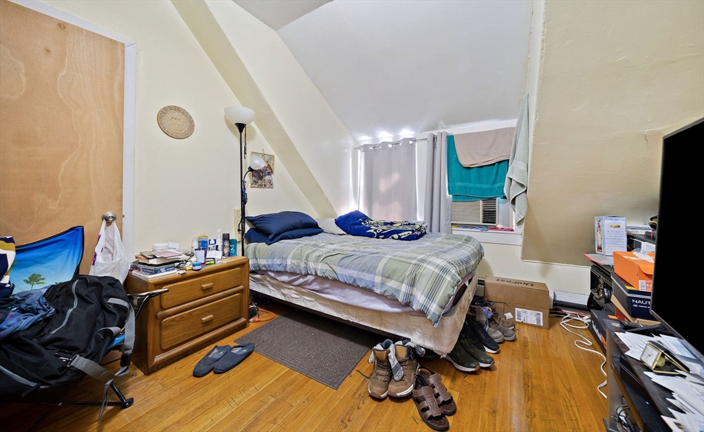45 May Street Worcester, MA 01610 - Photo 28 of 34 a bedroom with bed and a flat tv screen on the dresser