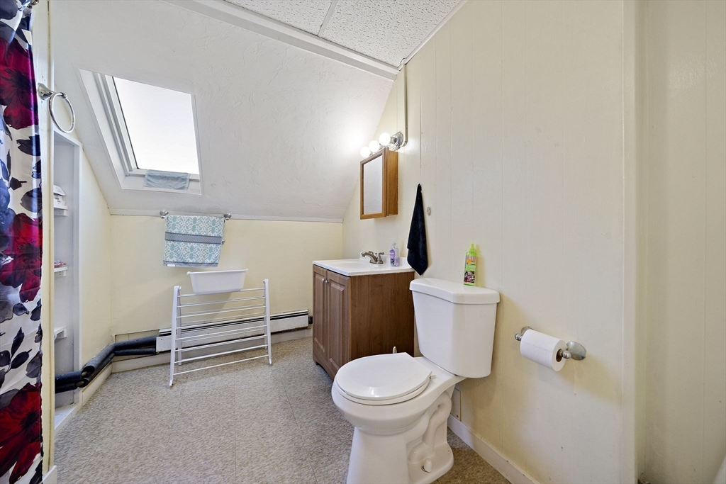 45 May Street Worcester, MA 01610 - Photo 29 of 34 a bathroom with a toilet sink and mirror