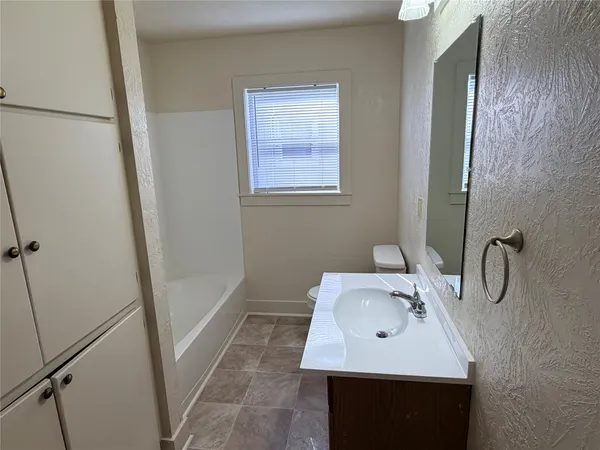 a bathroom with a sink toilet and a mirror