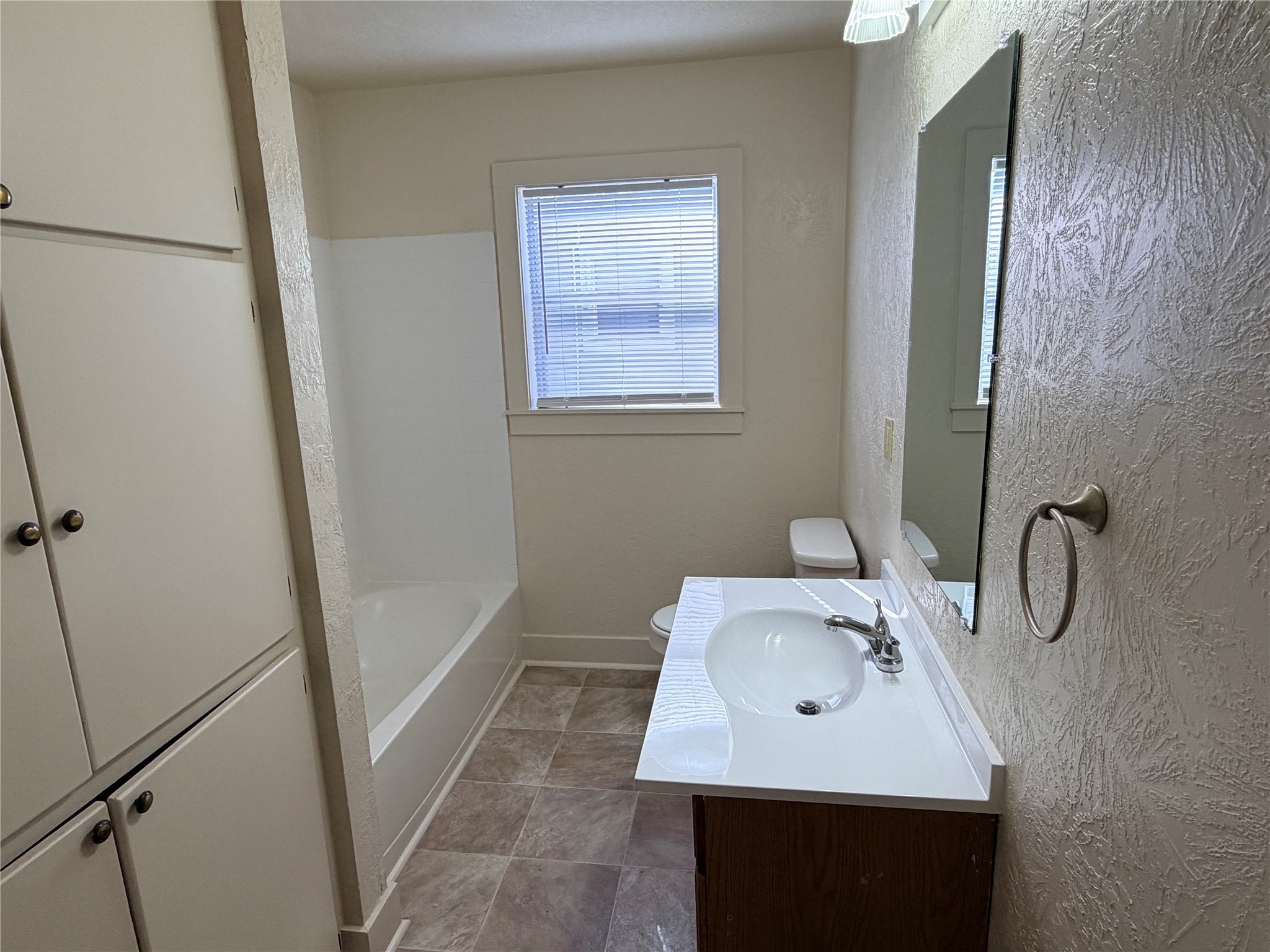 500 West Third Street Brenham, TX 77833 - Photo 11 of 16 a bathroom with a sink toilet and a mirror