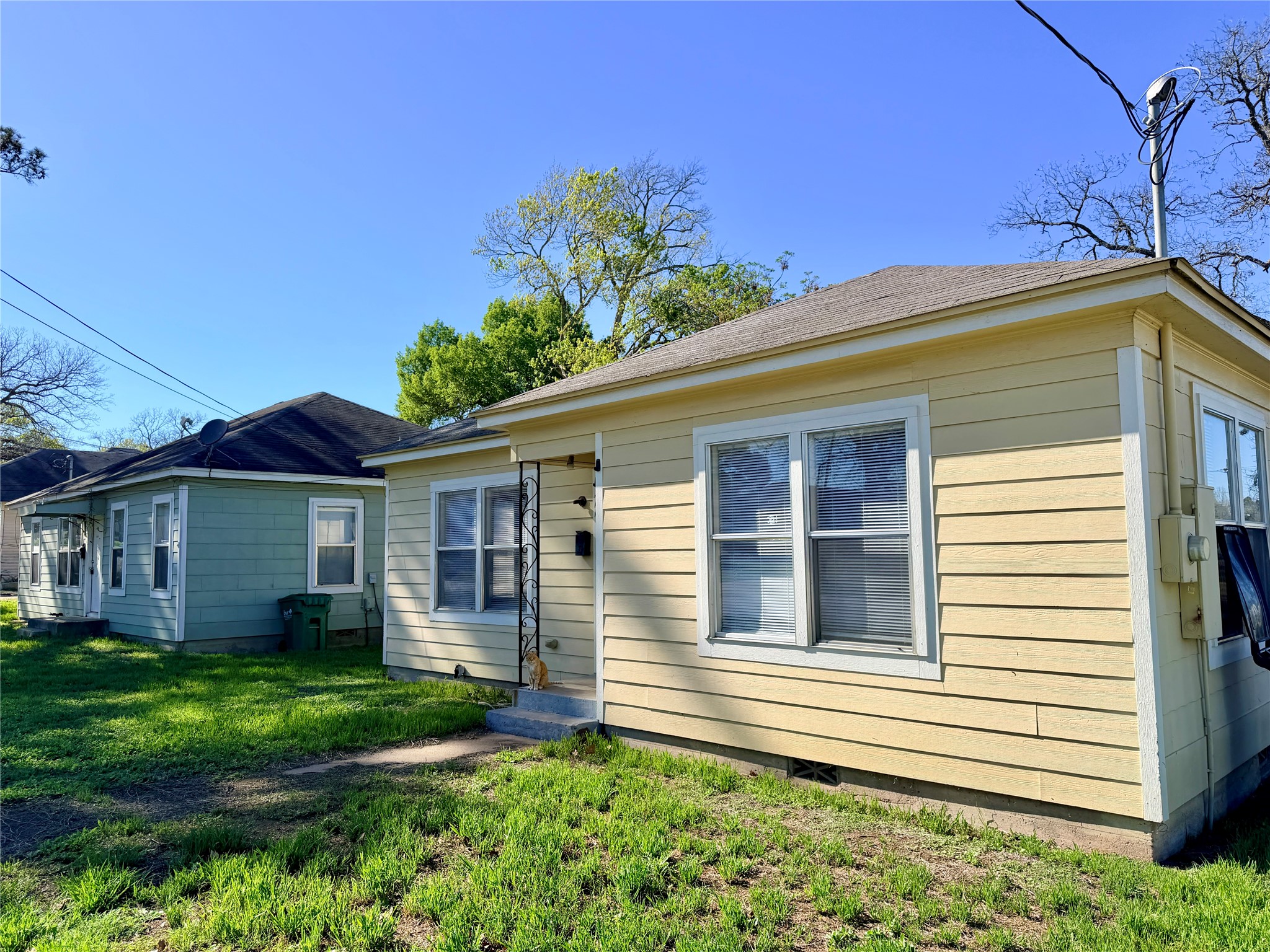500 West Third Street Brenham, TX 77833 - Photo 2 of 16 a view of a house with a small yard and a large window with potted plants