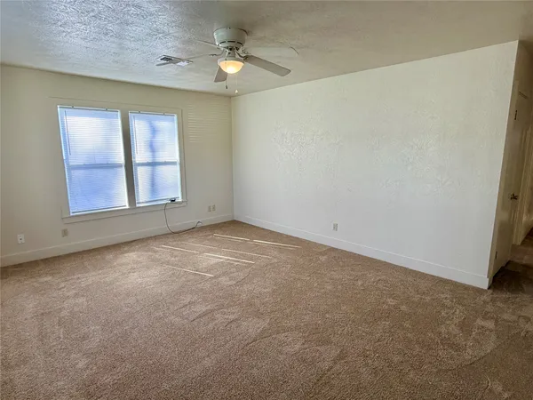an empty room with windows and closet