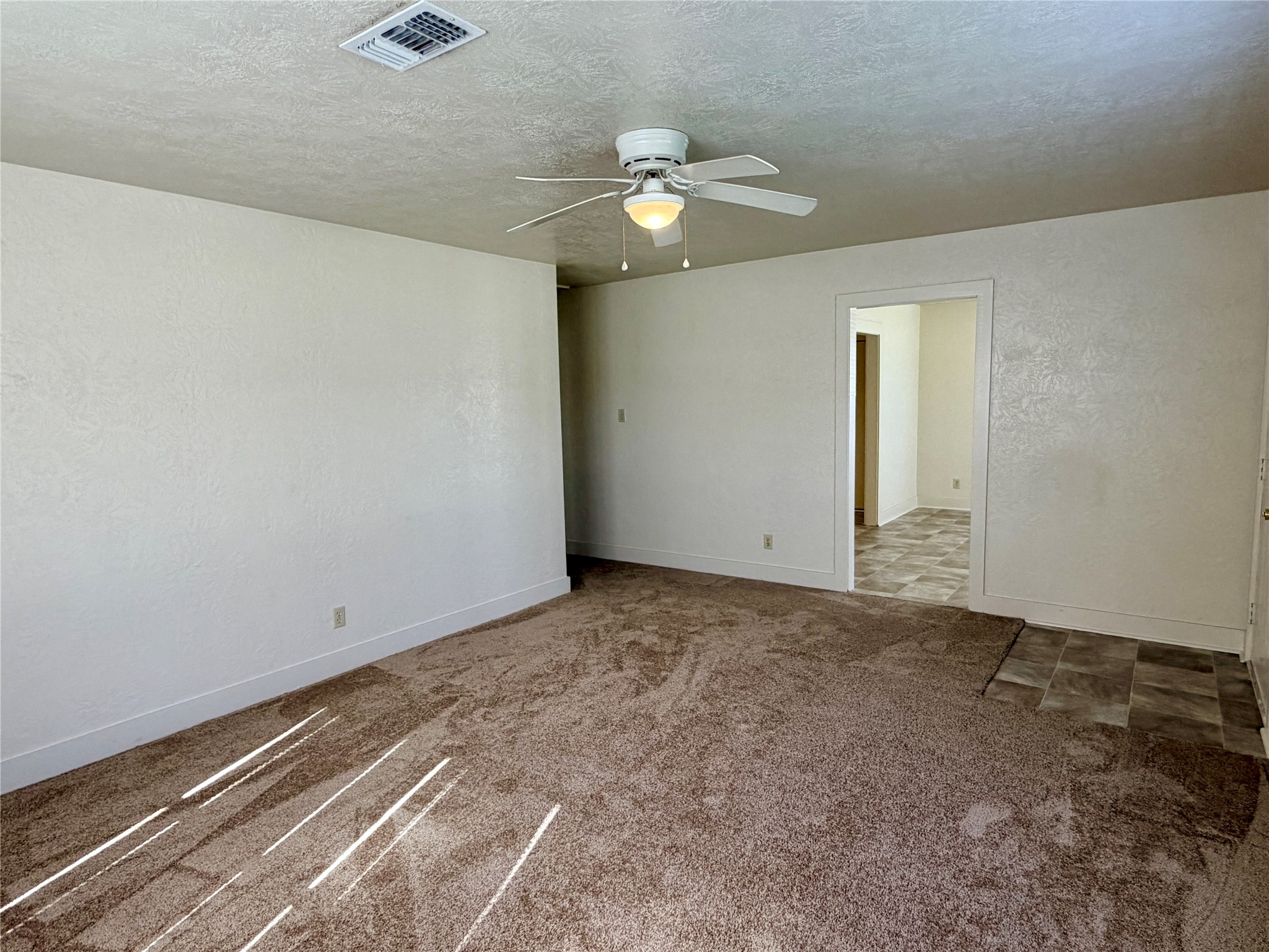 500 West Third Street Brenham, TX 77833 - Photo 5 of 16 a view of an empty room with a chandelier fan