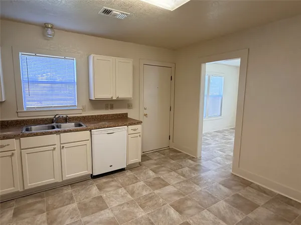 a view of a kitchen with a sink and cabinets