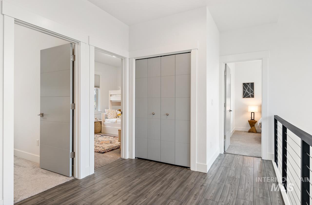 599 West Warren Street Boise, ID 83706 - Photo 32 of 41 Contemporary hallway featuring wood-finish flooring, crisp white walls, and modern gray doors