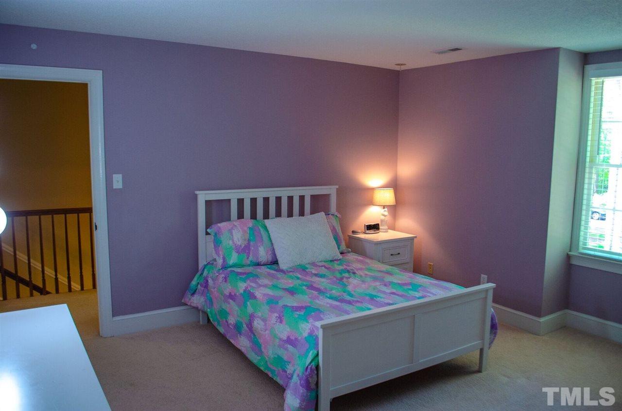 10016 Bushveld Lane Raleigh, NC 27613 - Photo 22 of 24 a bedroom with a bed and a window