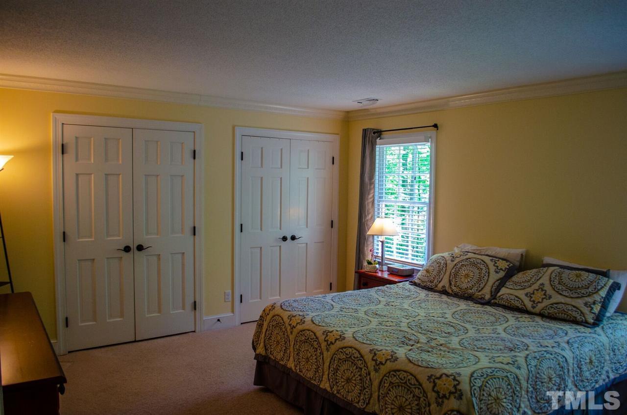 10016 Bushveld Lane Raleigh, NC 27613 - Photo 23 of 24 a bedroom with a bed and a window
