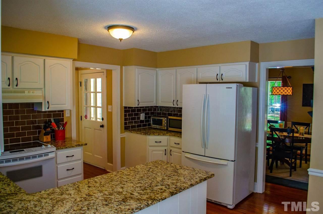 10016 Bushveld Lane Raleigh, NC 27613 - Photo 9 of 24 a kitchen with stainless steel appliances granite countertop a refrigerator and a stove