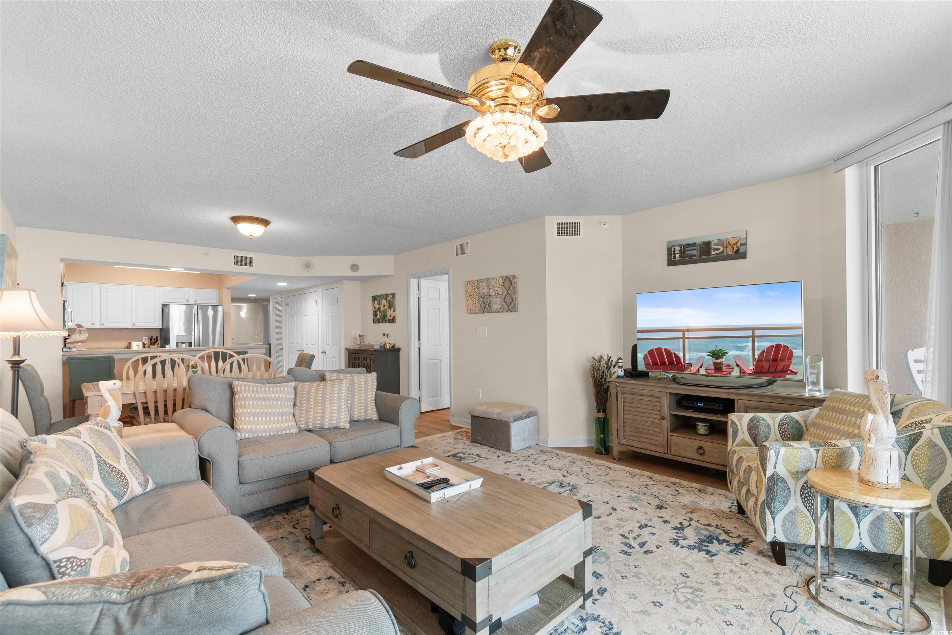 1003 South Ocean Boulevard, Unit 902 North Myrtle Beach, SC 29582 - Photo 14 of 40 Living room featuring a textured ceiling and a ceiling fan