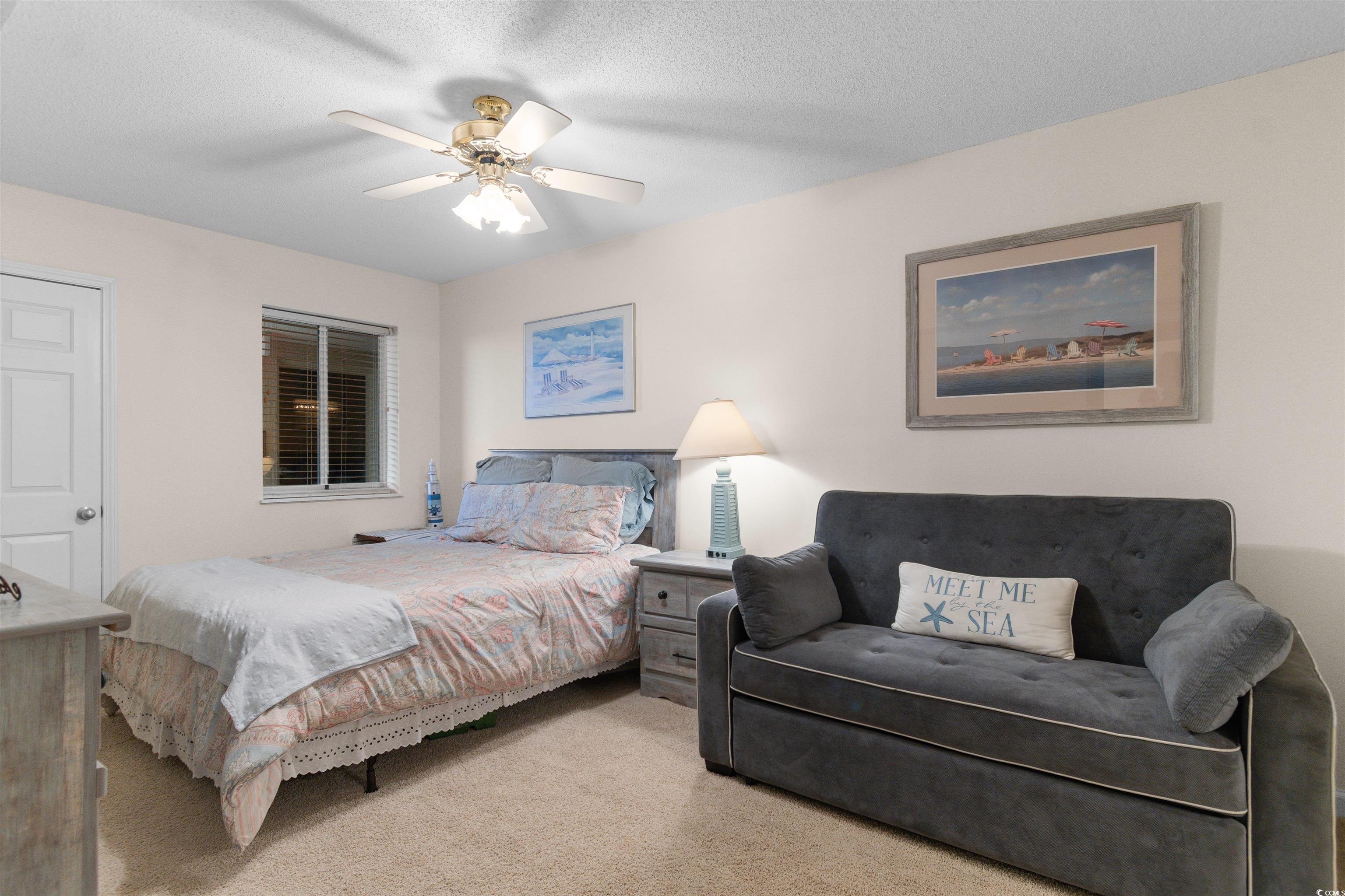 1003 South Ocean Boulevard, Unit 902 North Myrtle Beach, SC 29582 - Photo 21 of 40 Bedroom featuring carpet, a ceiling fan, and a textured ceiling
