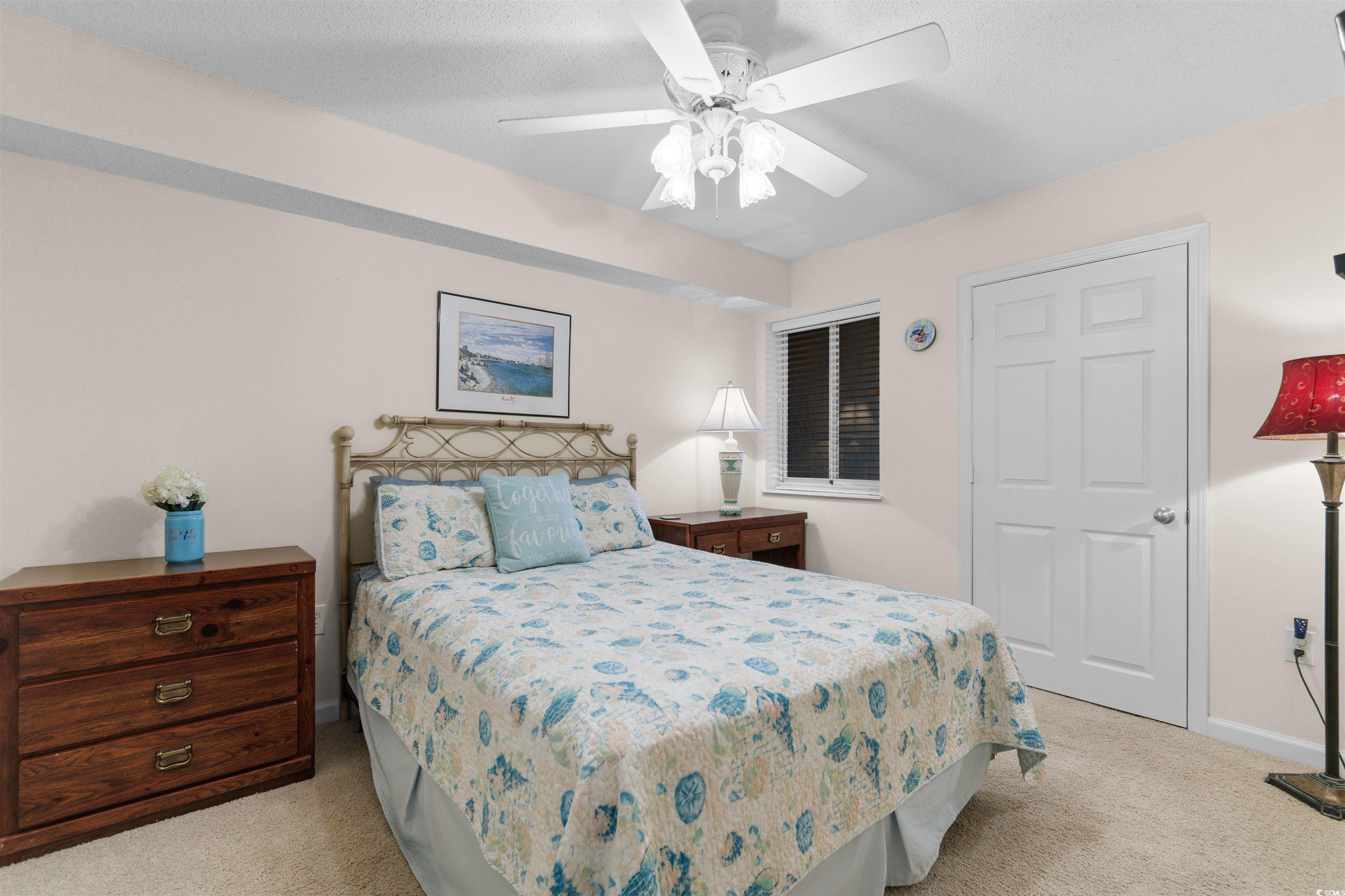 1003 South Ocean Boulevard, Unit 902 North Myrtle Beach, SC 29582 - Photo 24 of 40 Bedroom featuring light carpet and ceiling fan
