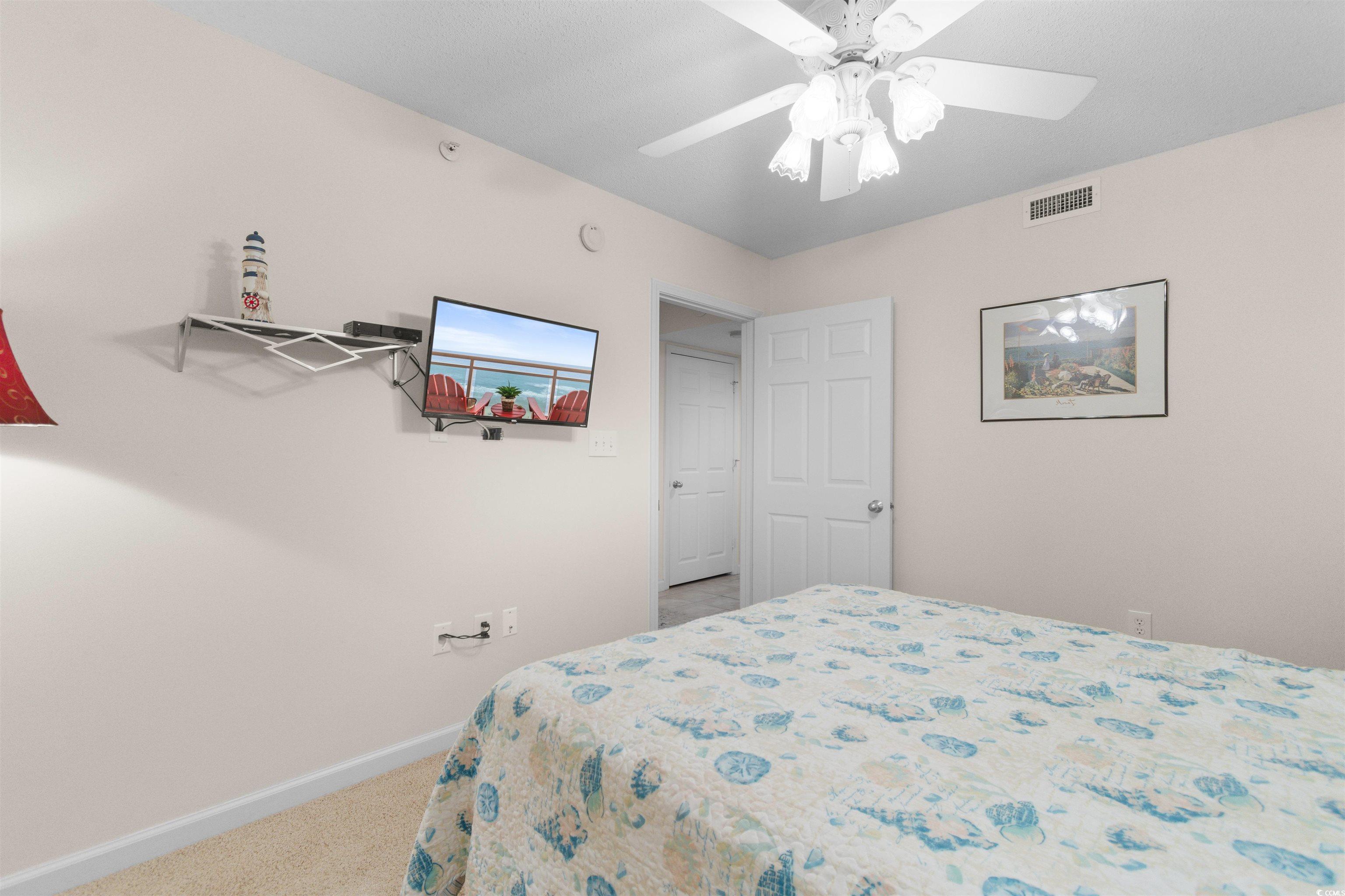 1003 South Ocean Boulevard, Unit 902 North Myrtle Beach, SC 29582 - Photo 26 of 40 Carpeted bedroom with baseboards and a ceiling fan