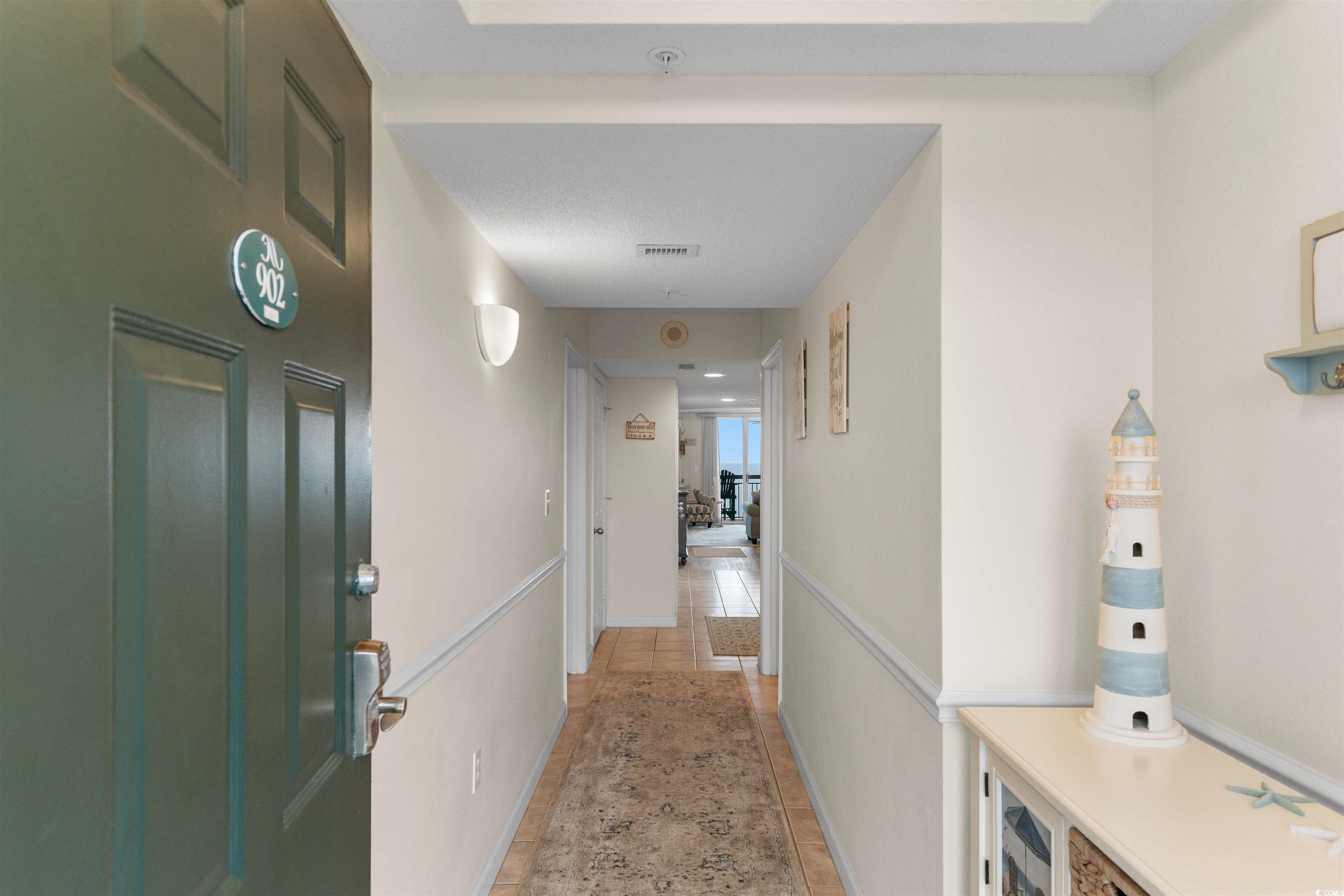 1003 South Ocean Boulevard, Unit 902 North Myrtle Beach, SC 29582 - Photo 4 of 40 Hall with light tile patterned flooring and baseboards