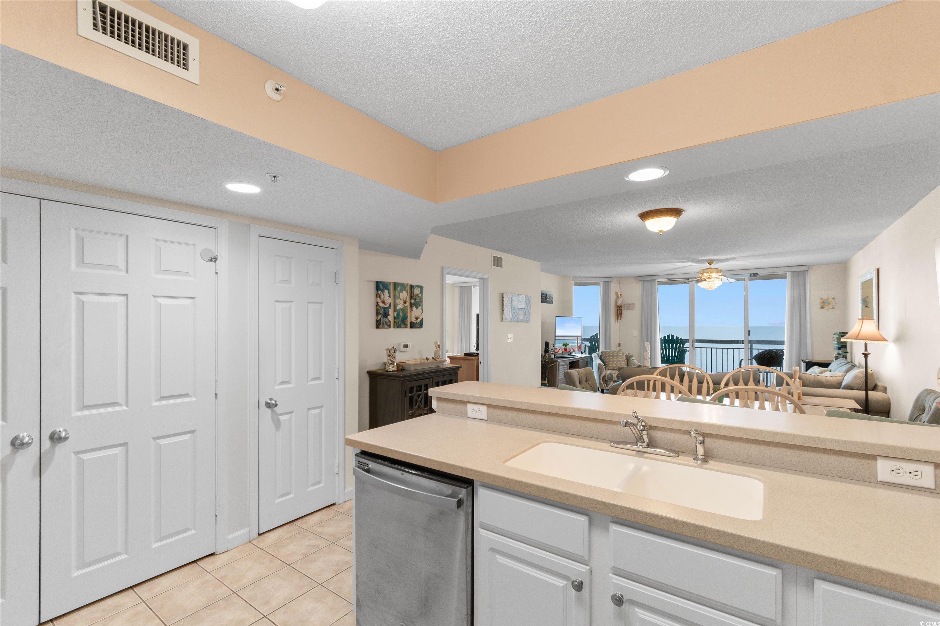 1003 South Ocean Boulevard, Unit 902 North Myrtle Beach, SC 29582 - Photo 39 of 40 Kitchen featuring open floor plan, dishwasher, light tile patterned floors, recessed lighting, and white cabinets