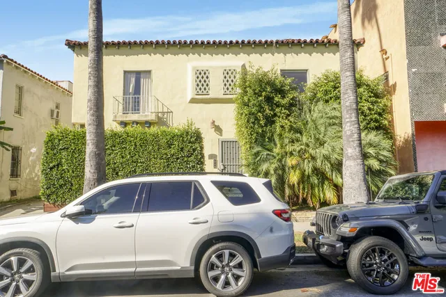 a front view of a house with parking space