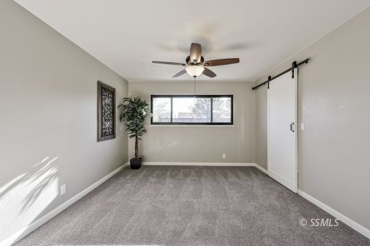 320 Dawn Court Ridgecrest, CA 93555 - Photo 20 of 24 a view of room with a ceiling fan and window