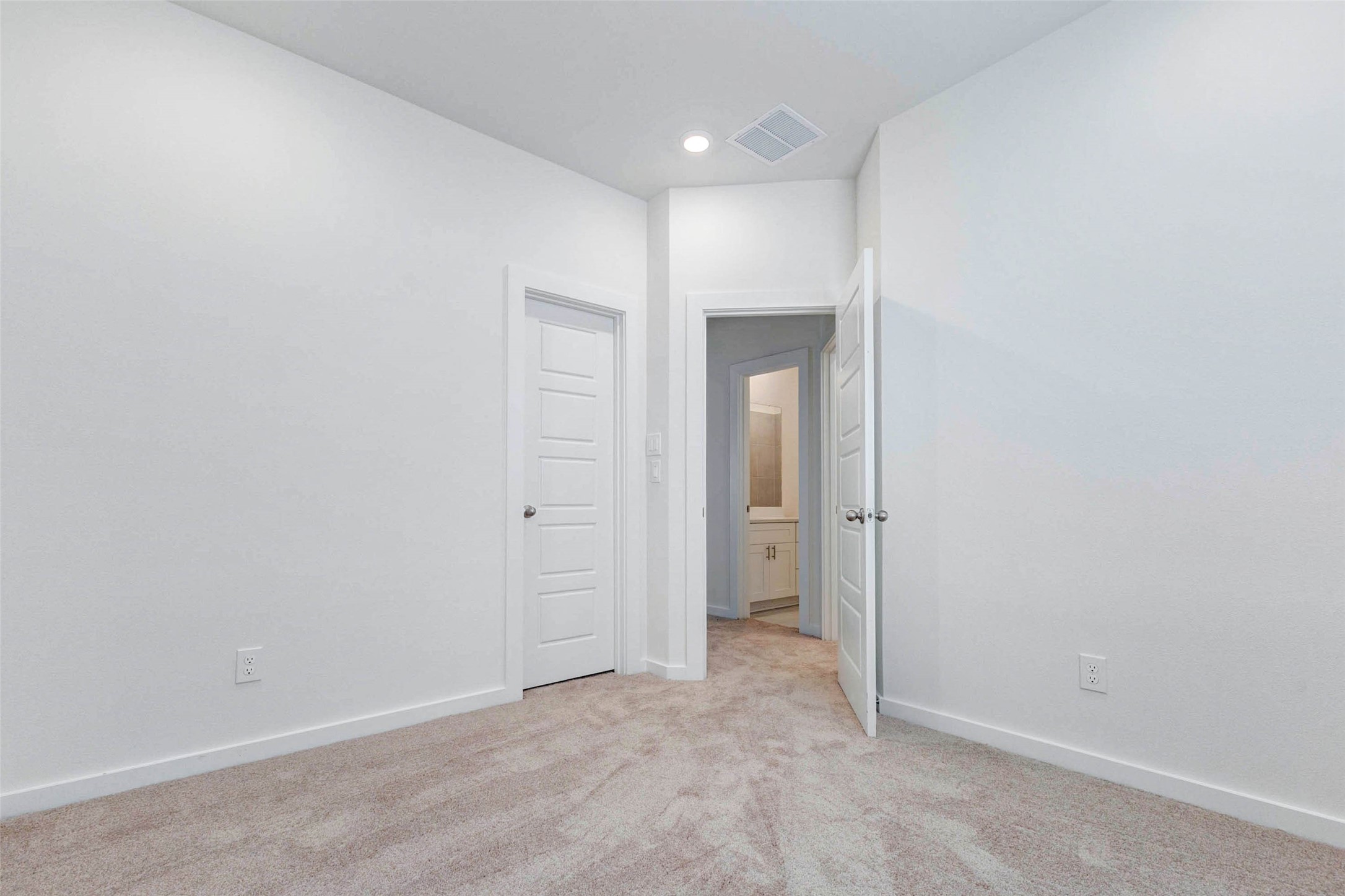 6475 Escondido Drive Rosharon, TX 77583 - Photo 24 of 32 Another bedroom view highlights the tall ceiling, soft carpet, clean white walls, and convenient door access to nearby spaces. The room offers a flexible layout with plenty of wall space, making it easy to arrange as a bedroom, office, playroom, or additional living space.