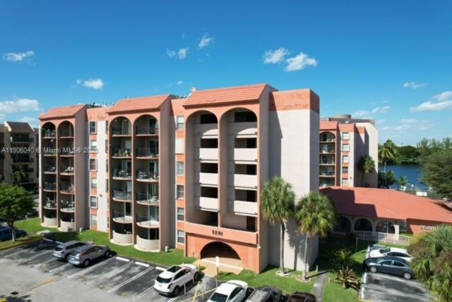 5201 Northwest 7th Street, Unit 507 Miami, FL 33126 - Photo 4 of 18 a front view of a building with a garden and plants