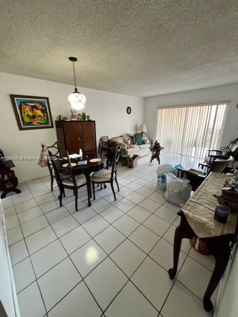 5201 Northwest 7th Street, Unit 507 Miami, FL 33126 - Photo 7 of 18 a living room with furniture and a chandelier