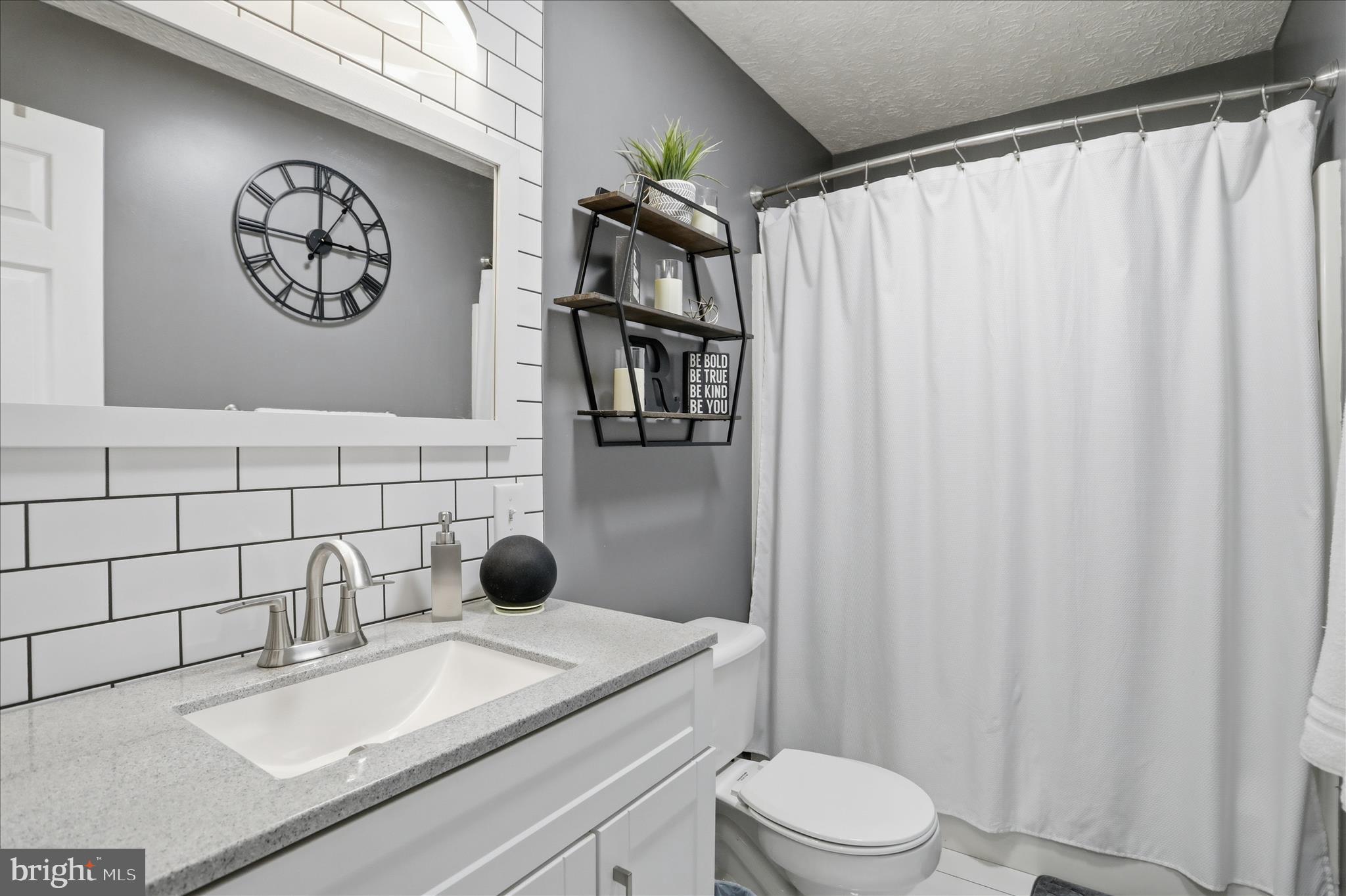 65 South Hummingbird Street Keyser, WV 26726 - Photo 24 of 30 a bathroom with a toilet sink and vanity