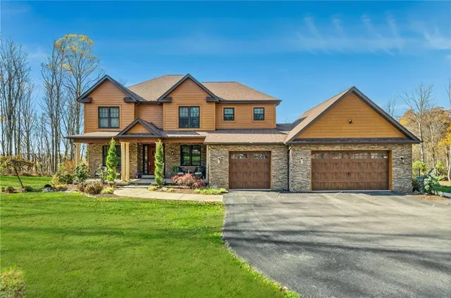 a front view of a house with a garden and yard