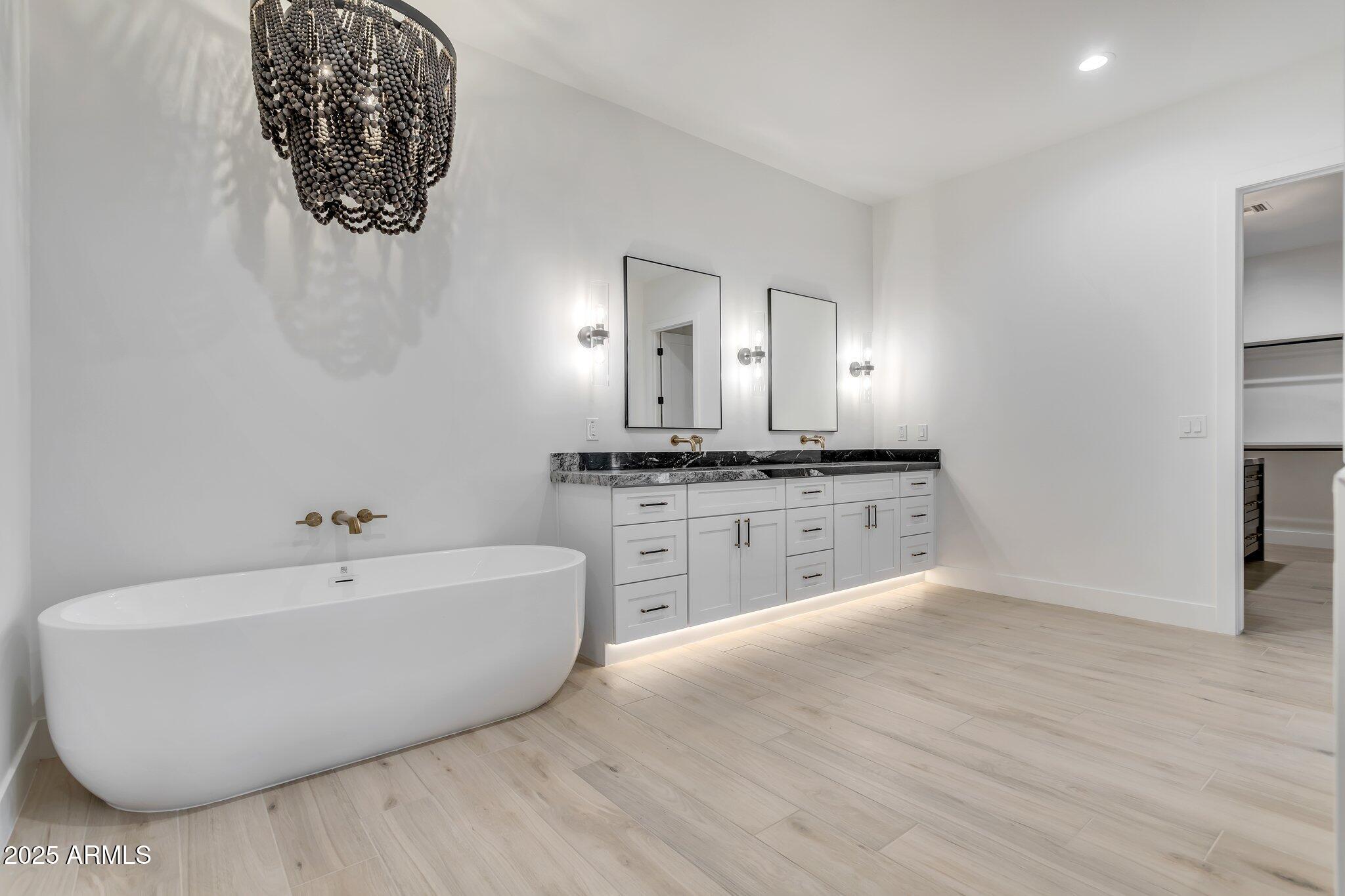 1602 East Cloud Road Phoenix, AZ 85086 - Photo 22 of 45 a spacious bathroom with a bathtub sink and a mirror