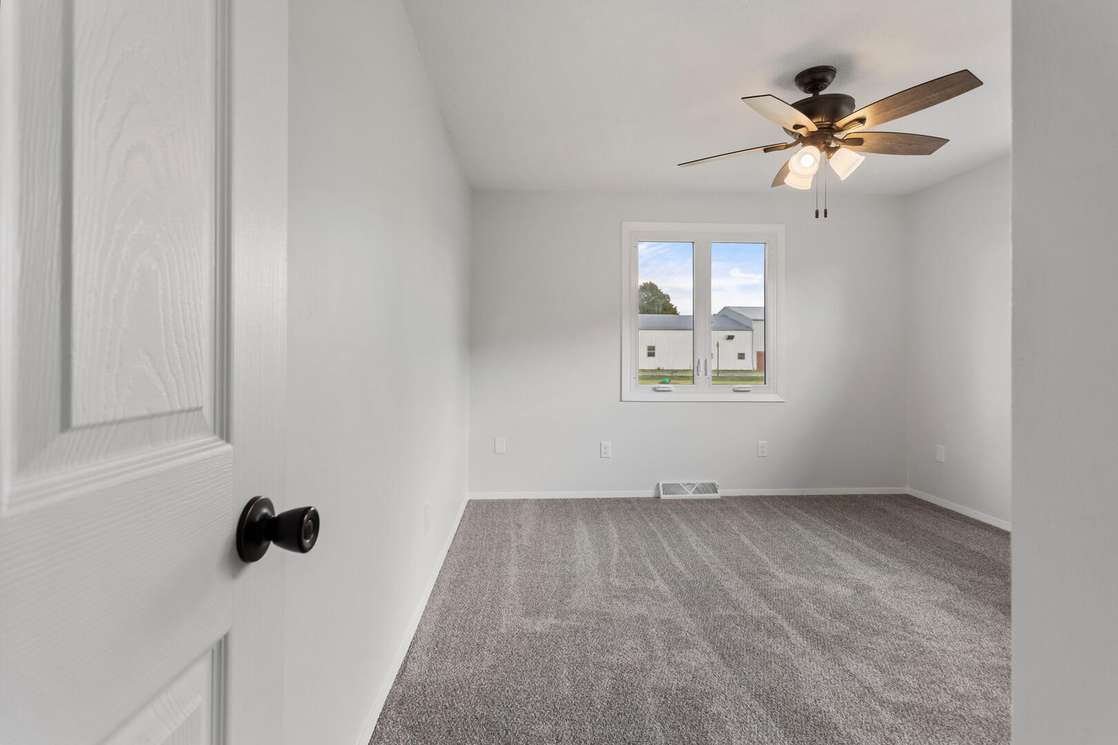 208 Maple Street Ogden, IL 61859 - Photo 15 of 30 an empty room with fan and windows