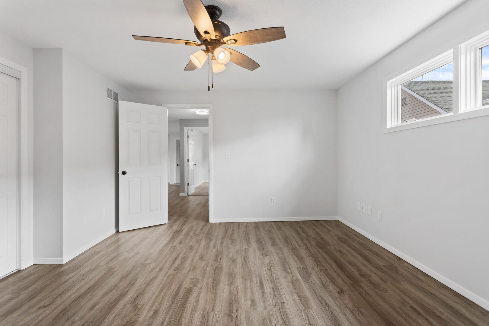 208 Maple Street Ogden, IL 61859 - Photo 19 of 30 wooden floor in an empty room with a window