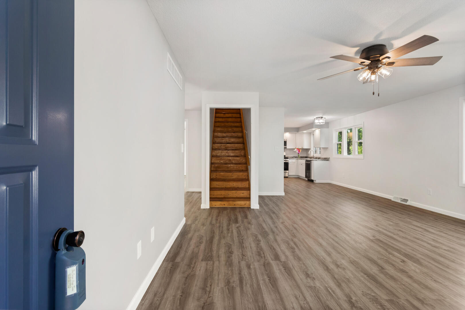 208 Maple Street Ogden, IL 61859 - Photo 4 of 30 a view of a livingroom with wooden floor and a ceiling fan